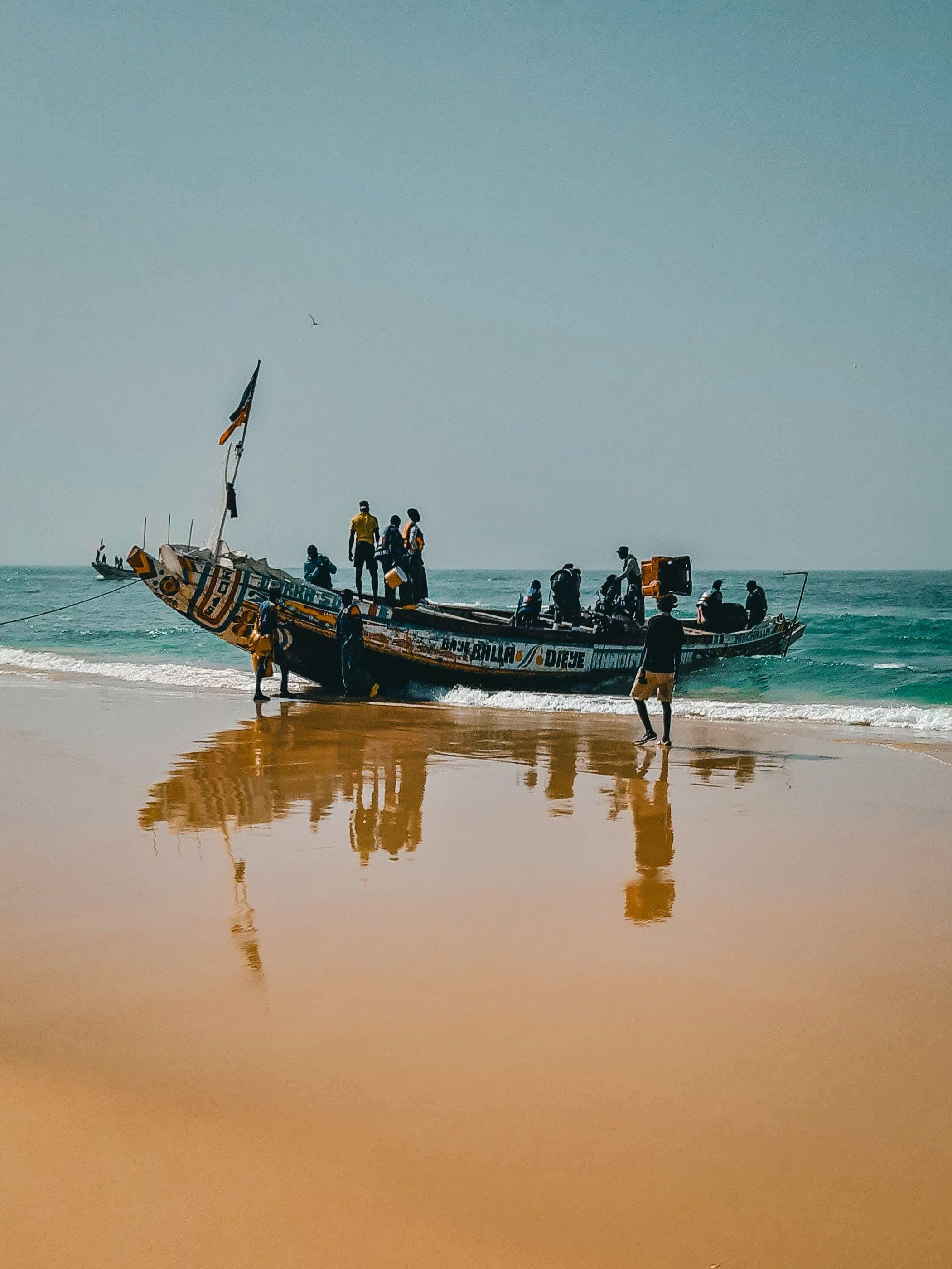 A fishing canoe and its crew on a West African beach